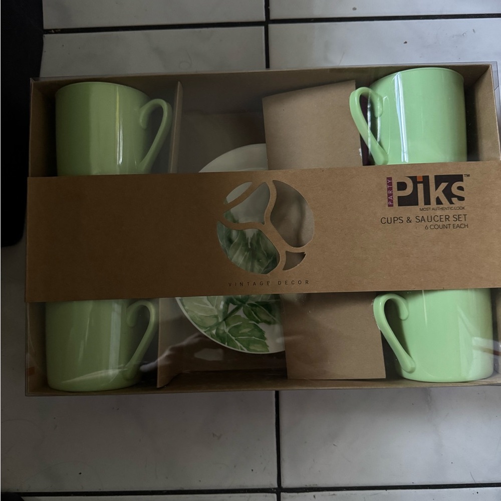 Set of 4 cups and 6 saucer plates. Brand new in box, never opened